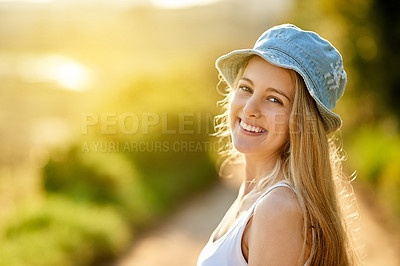 Buy stock photo Shot of a young woman on a tree stump out in the countryside