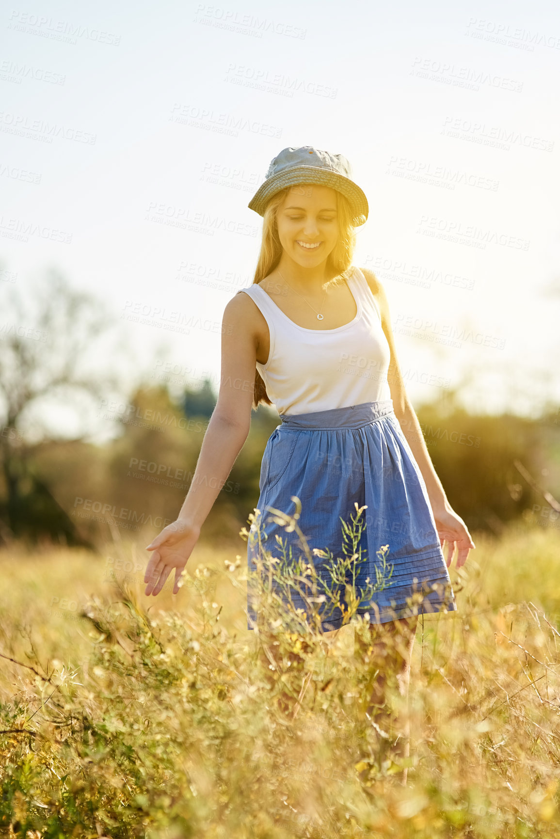Buy stock photo Young woman, plants and happiness in nature for freedom, travel and adventure in countryside. Gen z female person, smile and journey in natural environment with flowers, leaves and holiday in summer 