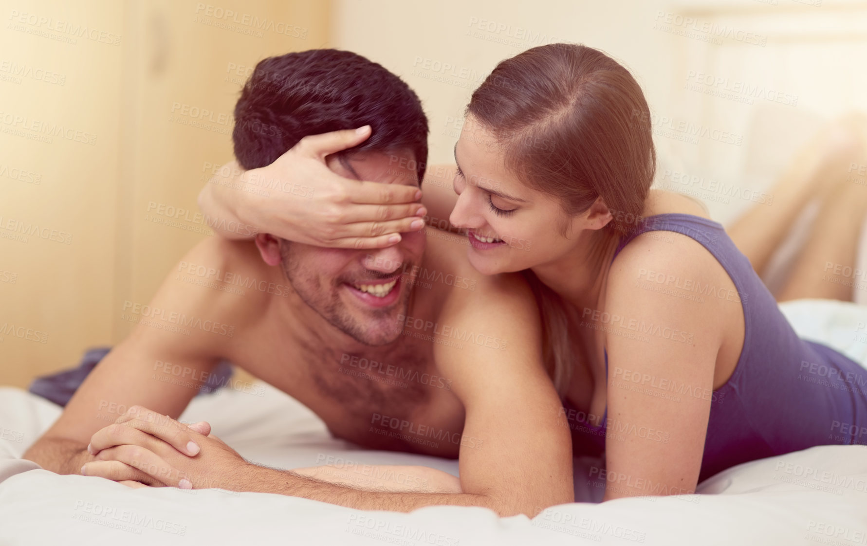 Buy stock photo Couple, bedroom and hand for covering eyes or relax, happiness and love in relationship. Man, woman and together with fingers for partners face in home, smile with playful bonding in apartment