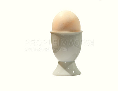 Buy stock photo A studio shot of healthy organic Eggs placed vertically isolated on a white background. The egg is kept in an off-white ceramic egg cup. Close-up shot of a white fresh Egg on white background.