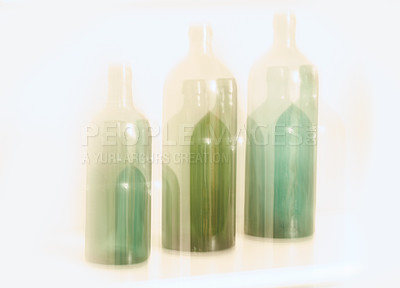 Buy stock photo Artistic design of old glass bottles with blury motion effect, isolated on white background. Abstract blurred colorful light on three green glass bottles. Long exposure effect of dreamy drunk vision