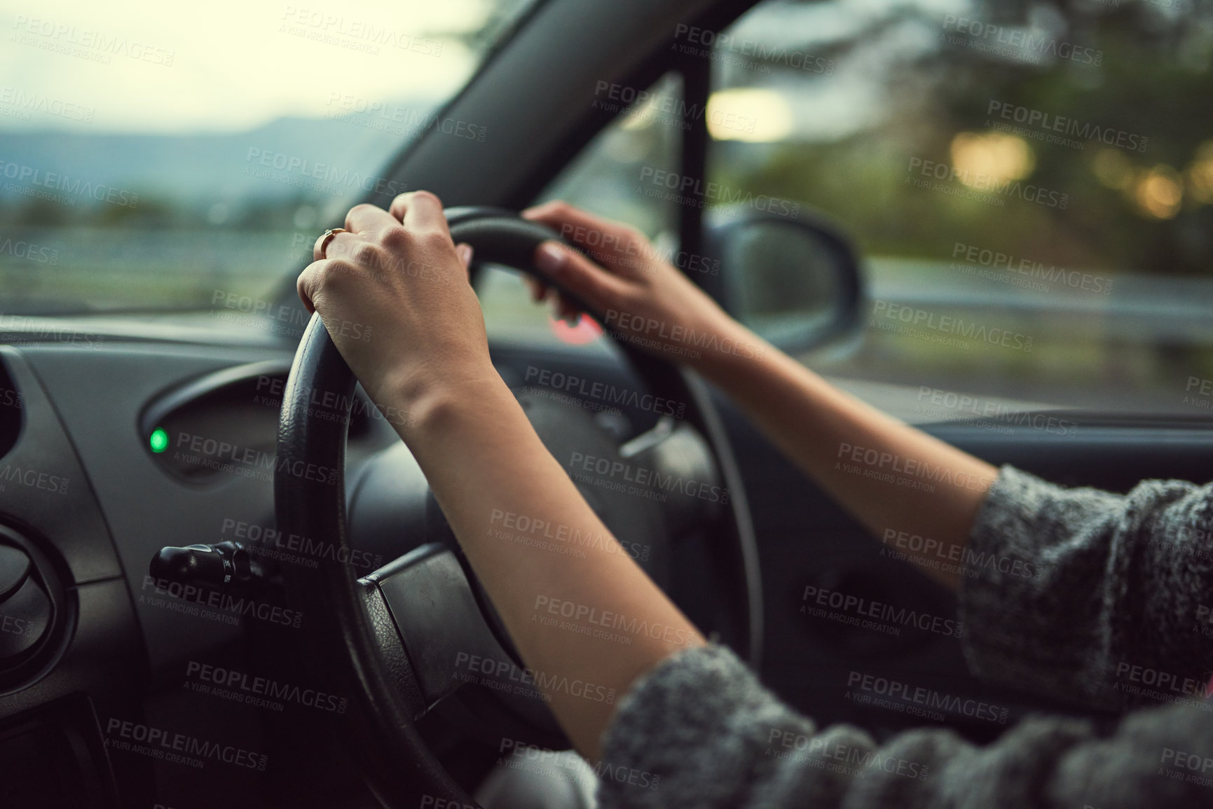 Buy stock photo Cropped shot of an unrecognizable woman driving her car