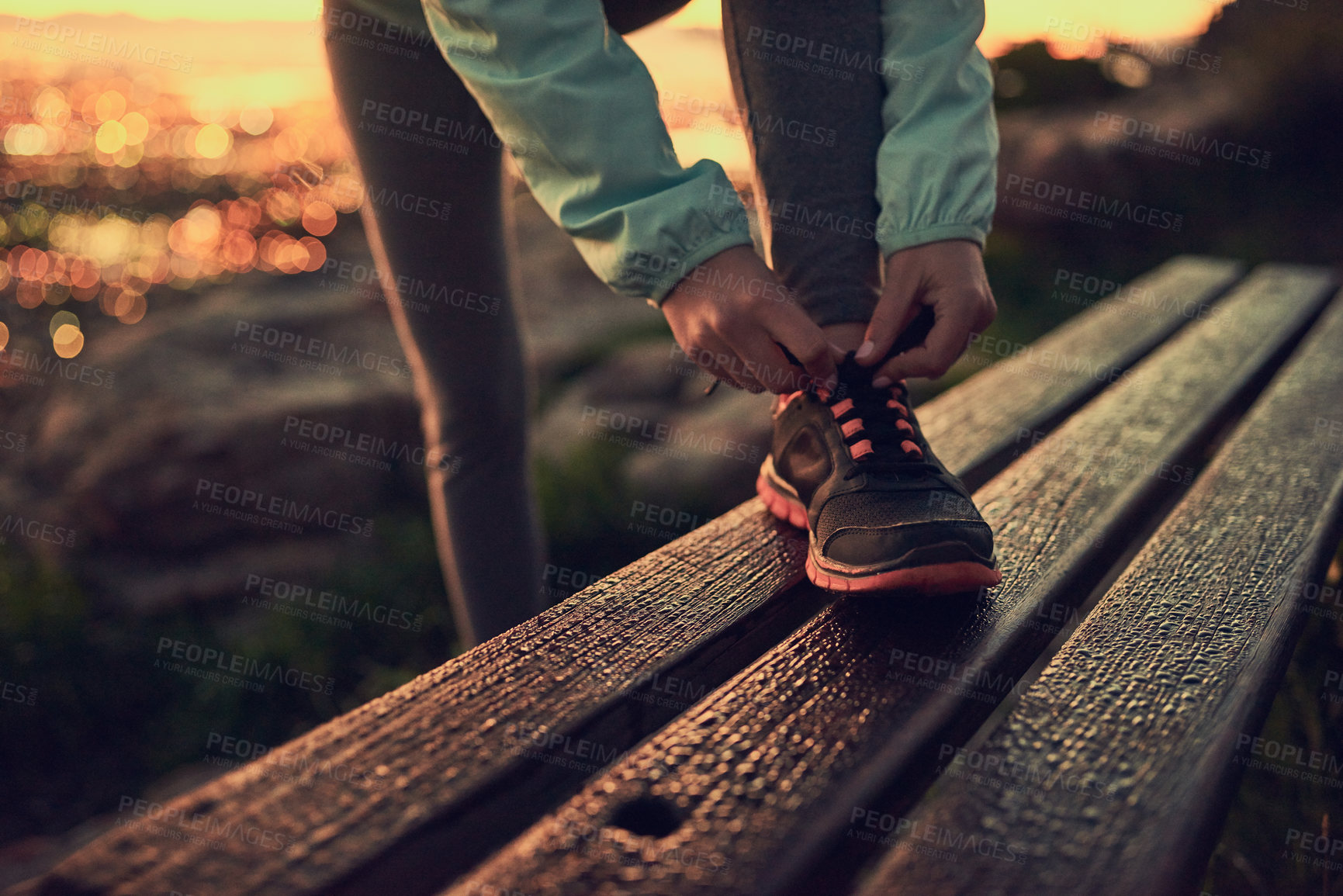 Buy stock photo Shot of an unrecognizable woman tying her shoe laces before a run