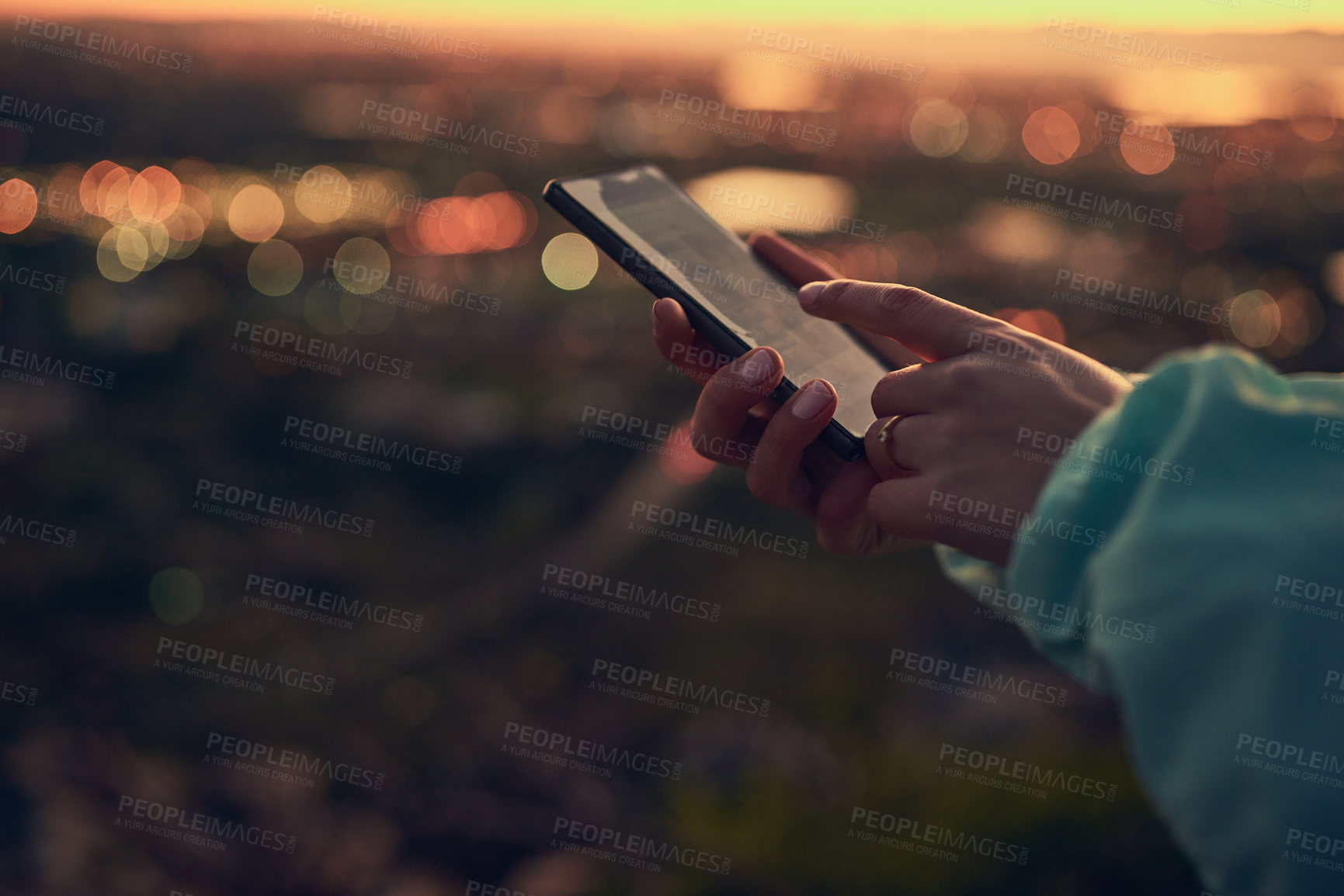 Buy stock photo Shot of an unrecognizable woman sending a text message while standing on a lookout point