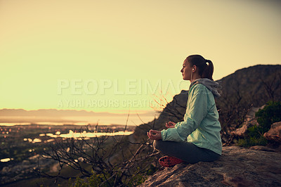 Buy stock photo Full length shot of a sporty young woman meditating outdoors