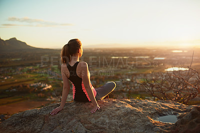 Buy stock photo Rearview shot of a sporty young woman taking in the view during a hike up the mountain