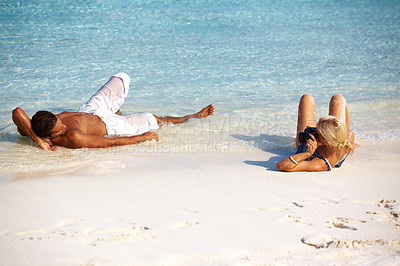 Buy stock photo Beach, tanning and couple relax on holiday in summer on vacation in Hawaii island by water. Travel, lying and sand outdoor with a tropical break by the ocean and sea on a honeymoon together in sun