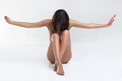 Buy stock photo Young woman sitting with her head down and arms outstretched while isolated on white
