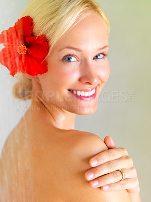 Buy stock photo Flower, shower and portrait of woman in bathroom of hotel for cleaning, wellness or hygiene on spa vacation. Tropical, water and washing with girl in villa resort for beauty, skincare or hospitality