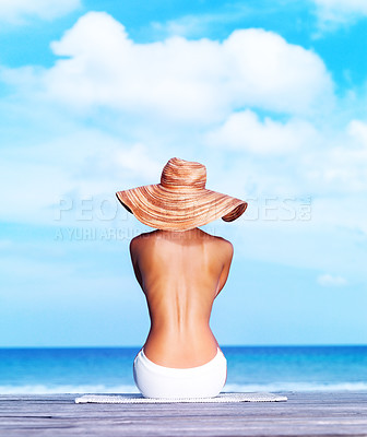 Buy stock photo Rear view of sexy topless woman sitting on a porch facing the sea