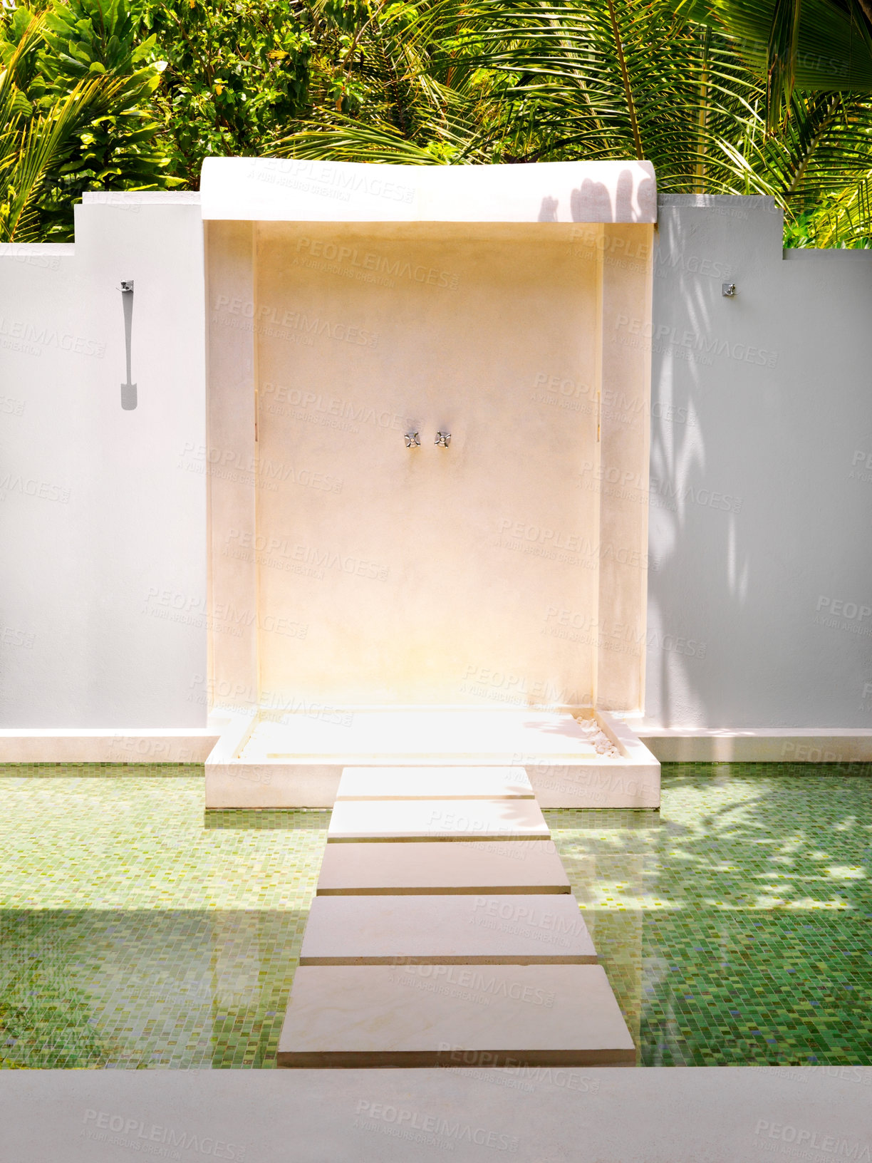 Buy stock photo An outdoor shower in a garden or resort with copyspace. Modern luxury showering facility with a stepping stone pathway across shallow water and copy space. Rinsing outdoors in nature at a spa 