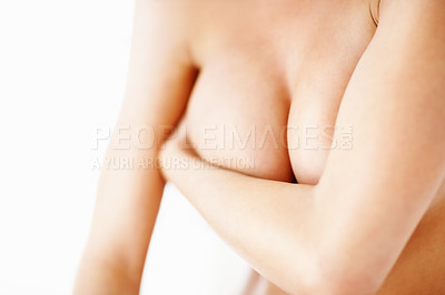Buy stock photo Nude, body and awareness for breast cancer with a woman closeup in studio isolated on a white background. Medical, health and wellness with a naked person covering her skin for plastic surgery