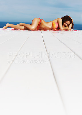 Buy stock photo Relax, sexy and bikini with black woman at beach for sunbathing, tropical and peace on Brazil vacation. Summer break, sun and blue sky with girl on deck of resort for travel destination and beauty