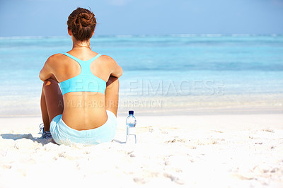 Buy stock photo Rear view of woman enjoying the view of horizon on beach after workout