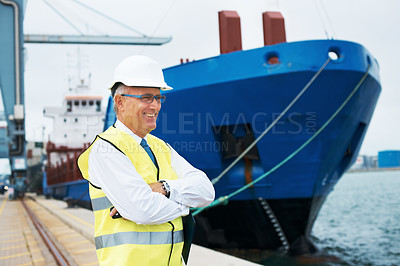 Buy stock photo A pleased dock worker standing at the harbor amidst shipping industry activity