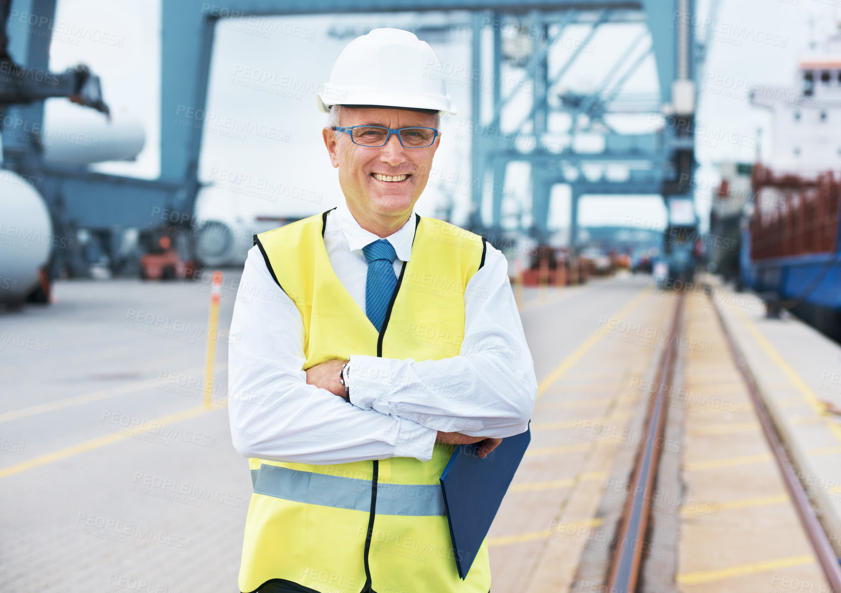 Buy stock photo Portrait of a dock worker standing at the harbor amidst shipping industry activity