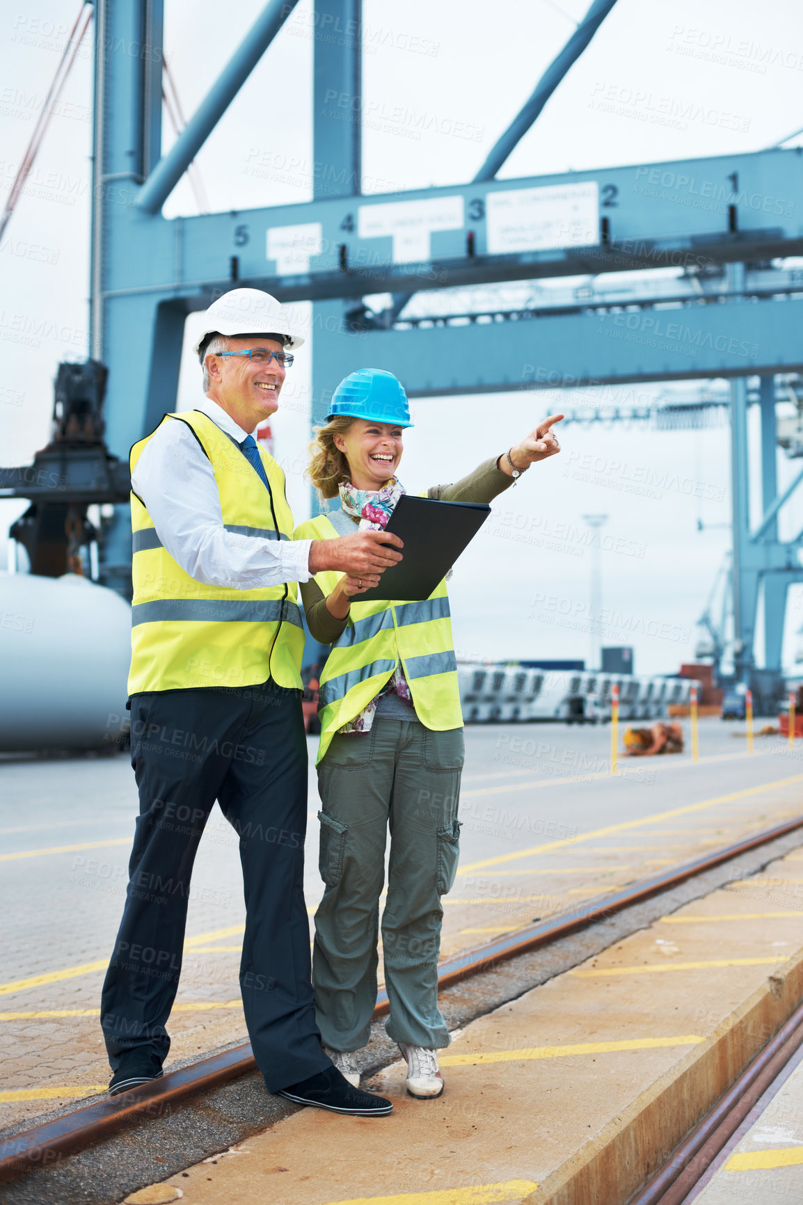 Buy stock photo Two engineers discussing planning on a site while looking away