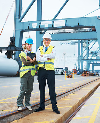 Buy stock photo Two engineers discussing planning on a site while in the shipyard