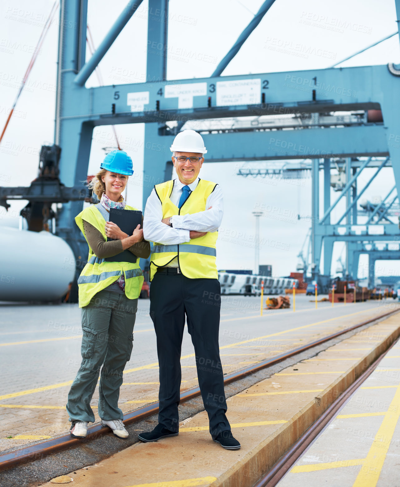 Buy stock photo Two engineers discussing planning on a site while in the shipyard