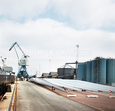 Buy stock photo Logistics, shipping and supply chain on a harbor with a factory, warehouse or plant and crane in the background. Manufacturing, cargo and freight for delivery in the export and import industry