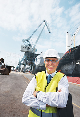 Buy stock photo Portrait of a dock worker standing at the harbor amidst shipping industry activity