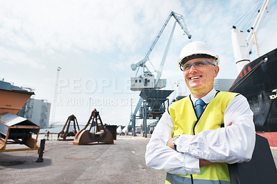 Buy stock photo A dock worker standing at the harbor amidst shipping industry activity