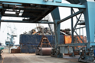 Buy stock photo A cargo container loaded with recycling material. A heap of containers of trash at the dockyard. A rail mounted large  gantry at the shipping yard. A container gantry crane used at shipping industry.