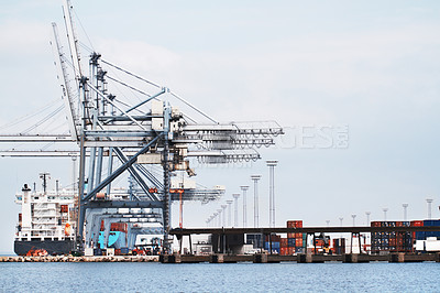 Buy stock photo A photo of a harbor with anchored ships, gantry cranes and containers.
