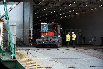 Buy stock photo Co-workers standing next to a truck on a loading dock.