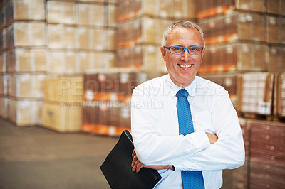 Buy stock photo A mature man standing inside a warehouse
