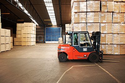 Buy stock photo A large warehouse storing big wooden boxes with a forklift