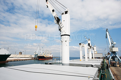 Buy stock photo A photo of a harbor with anchored ships with cranes