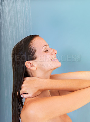 Buy stock photo Happy, beauty and skincare of woman in shower for bathroom, hygiene and luxury. Wellness, spa and dermatology with face of girl for facial, cleaning and hydration isolated on blue background studio