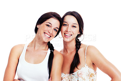 Buy stock photo Two happy teen girlfriends posing for the camera, isolated on white - copyspace