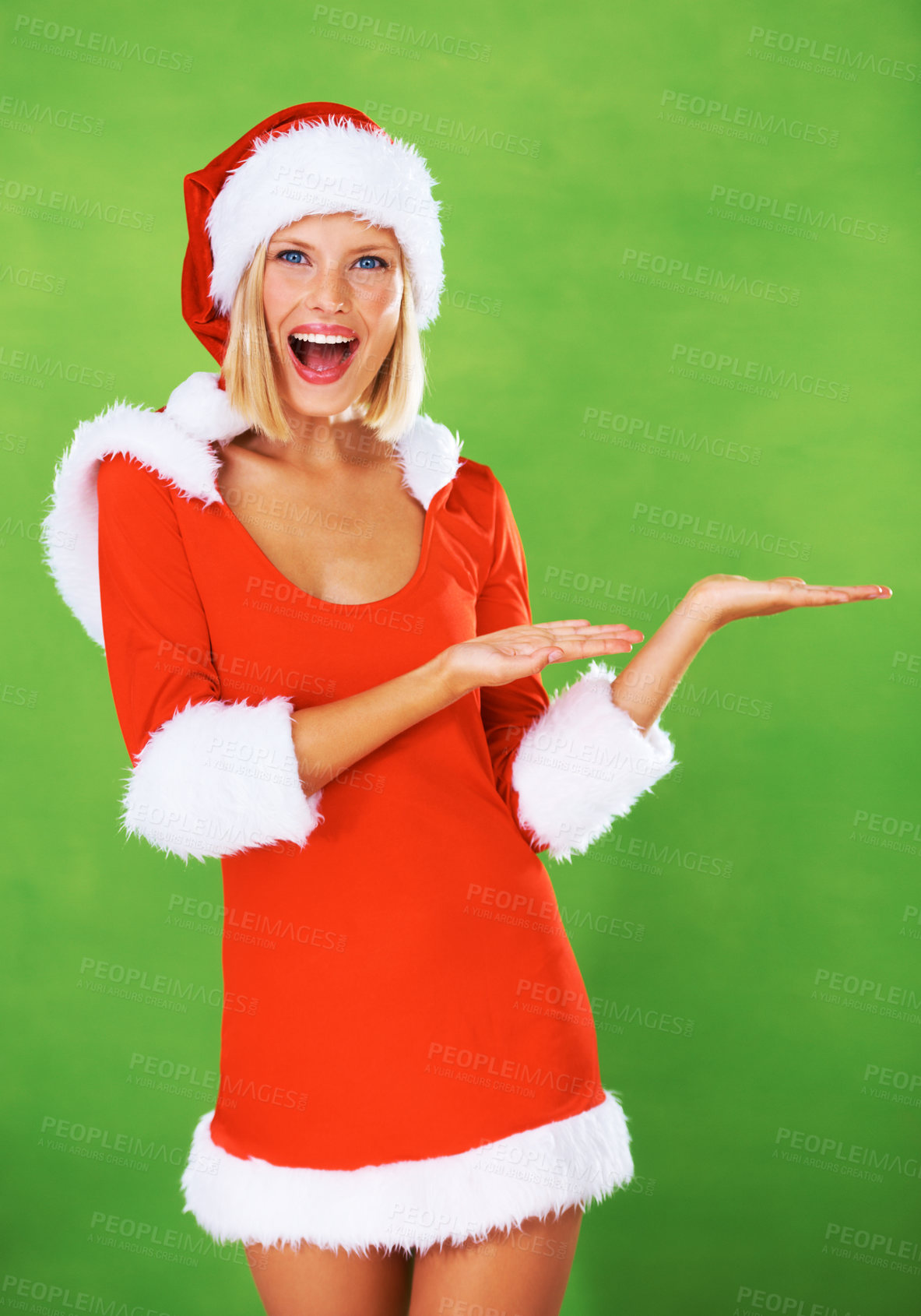 Buy stock photo Woman, santa and palm in studio with smile for festive holiday, celebration or advertising. Female person, Christmas hat and face on green background mockup for promotion, giveaway or present sales
