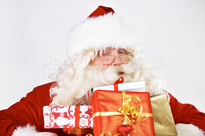 Buy stock photo Christmas, santa and gift portrait with wink for traditional  festive holiday advertising. Present, giving and santa claus man with colorful ribbon boxes on white studio mockup marketing.

