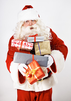 Buy stock photo Senior man, santa claus or presents by white background in studio for delivery, celebration or holiday event. Retirement elderly, festive christmas costume or xmas parcel gift box on mockup backdrop
