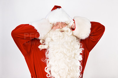 Buy stock photo Santa claus, ears and noise stress for holidays, celebration or frustration. Father Christmas, suit and hand gesture for headache or pain for vacation, work burnout or loud in studio white background