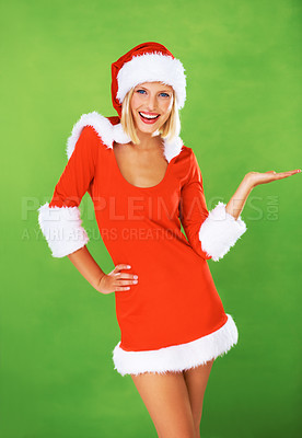 Buy stock photo Happy woman, palm and studio portrait for Christmas celebration, presentation or advertising. Female person, red costume and smile or hand gesture for festive season holiday gifts on green background