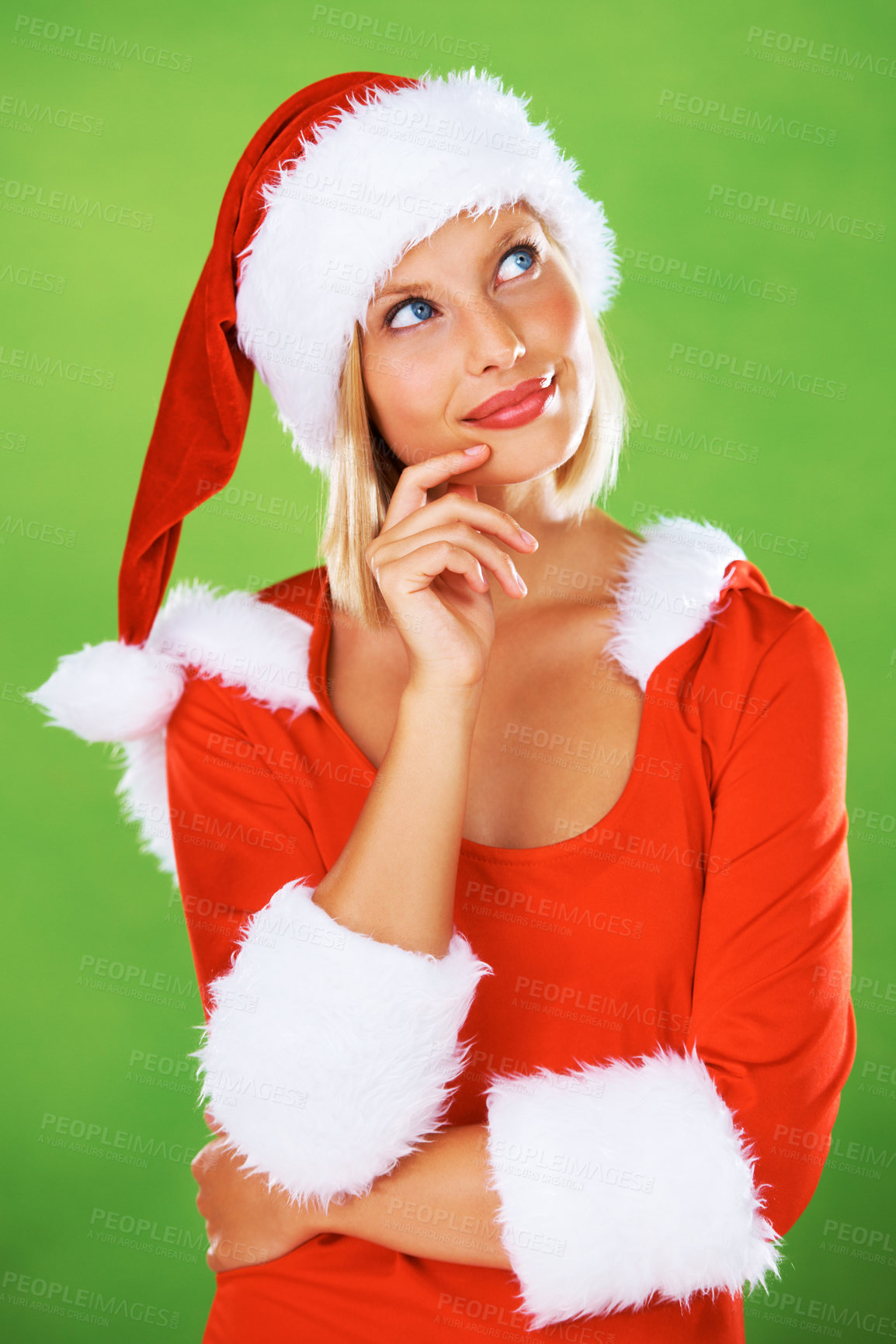 Buy stock photo Christmas, woman and thinking on studio green background about ideas, question and dream of celebration, holiday and winter event. Model in festive red costume, santa hat and wondering about decision