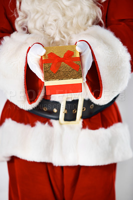 Buy stock photo Santa claus, present and hand or closeup for Christmas giving, festive season, or fun celebration. Male person, gift box joy and red costume on white background or holiday vacation or winter break