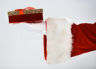 Buy stock photo Cropped image of Santa holding a single present, with bow, in his white gloved hand