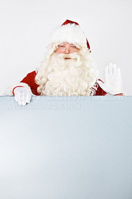 Buy stock photo Santa claus, poster and promotion space for holiday special, branding or mockup. Father Christmas, portrait and wave for presenting billboard on white background for marketing, sales for winter beak