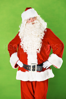 Buy stock photo Santa claus, hands and hips in studio portrait for Christmas holiday, festive season or warning. Male person, costume suit and arm gesture on green background for vacation, celebration or gift giving