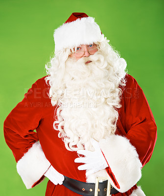 Buy stock photo Santa claus, serious and portrait in studio for Christmas season, joy celebration or winter holiday. Male person, tired and face or red outfit on green background as mockup, festive fun or vacation