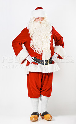 Buy stock photo Santa claus, wink and man in costume in a studio for christmas, fun and hands on hip against a white background mockup. Santa, senior man and emoji portrait by playful male in festive celebration