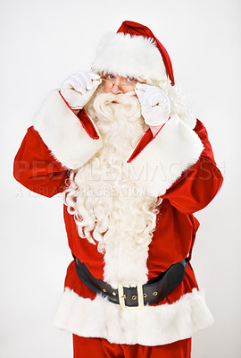 Buy stock photo Santa claus, playful and portrait in studio for Christmas holiday, festive season or celebration. Male person, red outfit and glasses as white background mockup for greeting, vacation or winter break