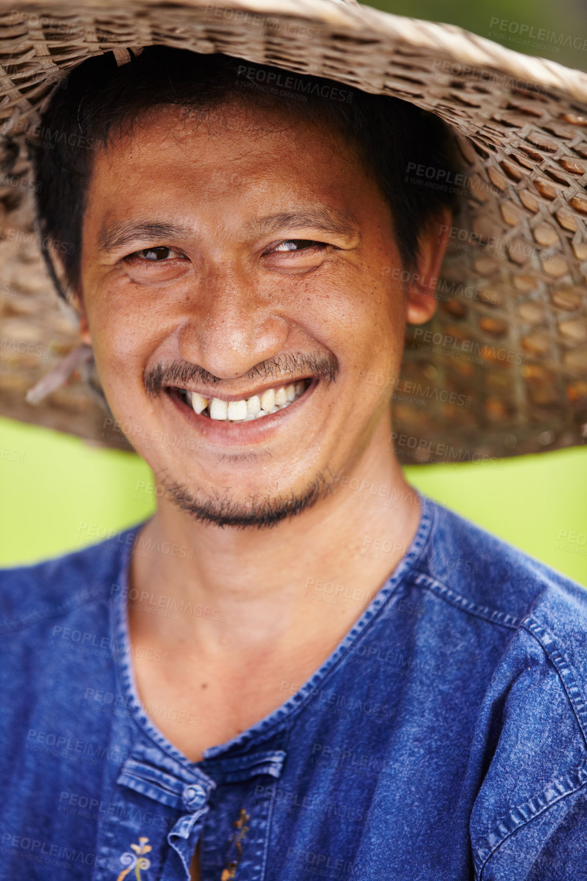 Buy stock photo Closeup portrait of a Thai rice paddy worker wearing a traditional hat