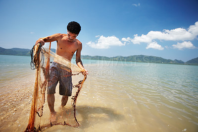 Buy stock photo Fisherman, sea and man with net working, nature and labor with fishing in Thailand and tropical island location. Ocean, job and rope with worker in water to catch fish and beach with environment