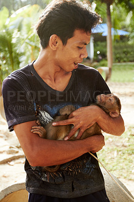 Buy stock photo Zoo, animal and man with monkey in nature for care, conservation and wildlife rescue. Sanctuary, travel and happy person with macaque in environment, ecosystem and outdoors in Thailand for tourism